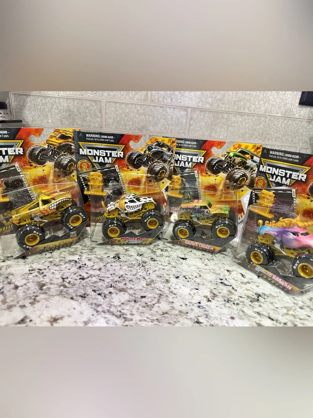 Set of all four. Monster Jam 1:24 Gold Series Die-Cast Trucks.